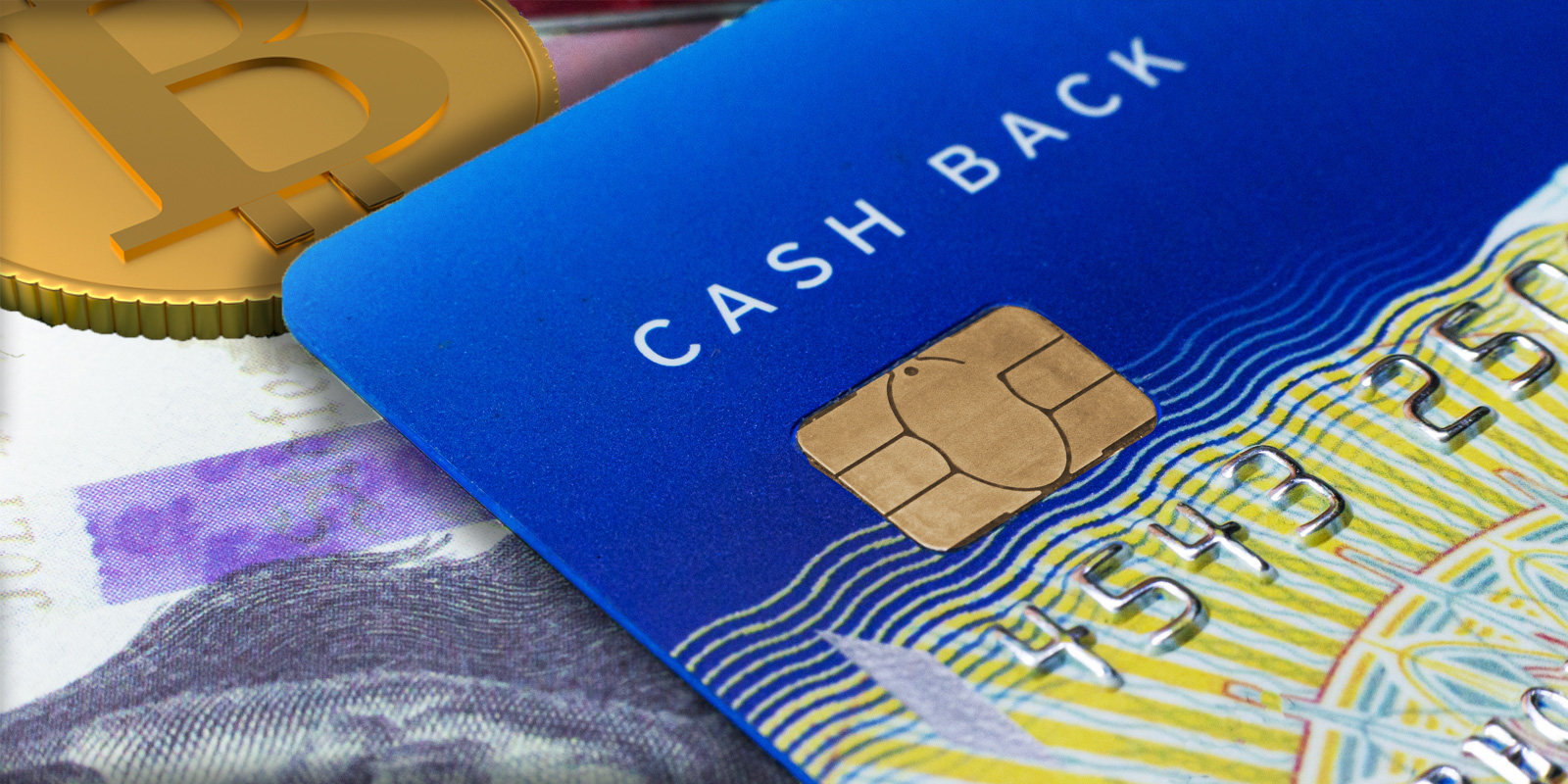 Close-up of a blue cash back credit card with a Bitcoin coin and paper currency in the background symbolizing cryptocurrency and digital payments.