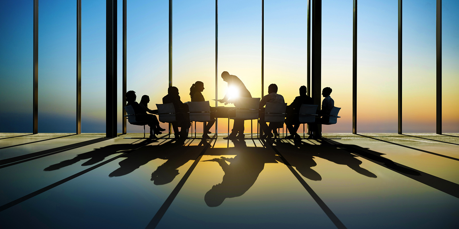 group of people meeting together at a conference table