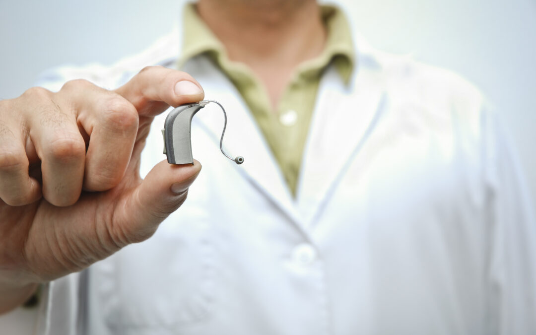 Woman holding hearing aid